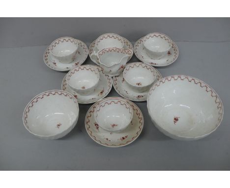 A set of six 19thC continental tea bowls and saucers with rust coloured hand painted floral decoration to twist bowls, sugar 