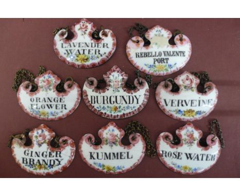 A Collection of eight 19th/20thC enamel decanter labels with floral decoration 