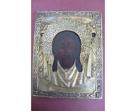 19thC Russian silver icon of the head of Christ with a silver halo held in an outer glazed case, gilt framed, oil painted on 