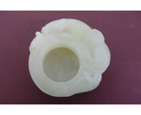 A small Chinese pale green jade brush water pot with winged lion and cub to border - width 2ins , height 5/8 inch 