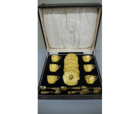A cased set of six Coalport coffee cups and saucers in yellow glaze with gilt decoration 