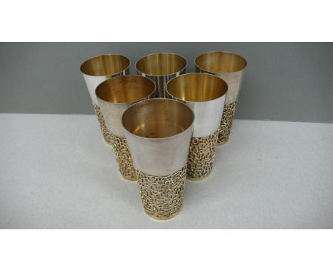 A set of six Stuart Devlin parcel gilt silver beakers with blind fretwork decoration to lower half of body - London 1968 - 57