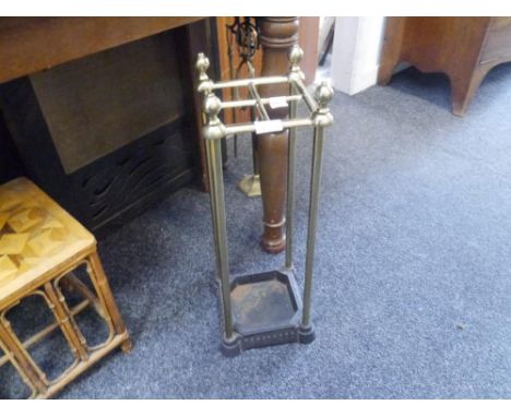 An Edwardian brass and cast iron stick stand with original liner