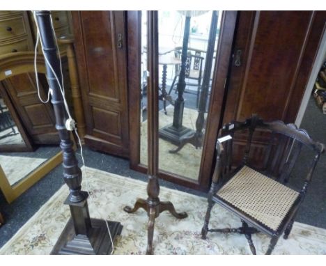 An early 20th century floor lamp with reeded upright on a tripod base