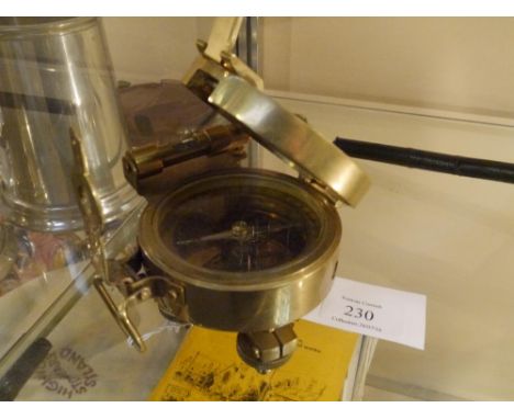A Stanley brass compass on pivot stand with level, mirrored cover, and sights