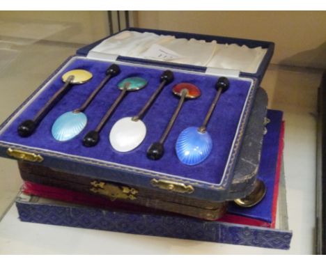 A cased set of six silver coffee bean spoons, together with a cased set of six multi coloured enamel silver hallmarked coffee