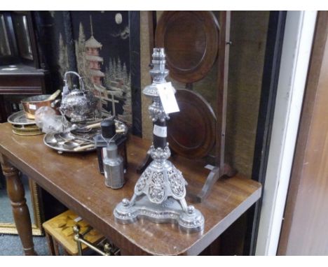 A white metal  table lamp, possibly originally the base of an oil lamp