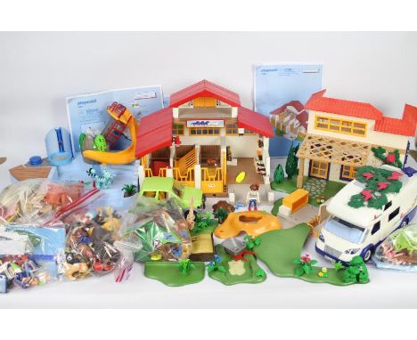 Playmobil - A large quantity of Playmobil items including car, camper van, swimming pool, stables and figures. They show ligh