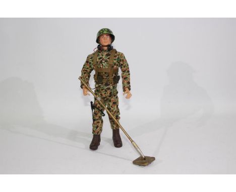 GI Joe, Hasbro - An unboxed vintage Hasbro GI Joe action figure in Marine Demolition outfit. The red painted hard head figure