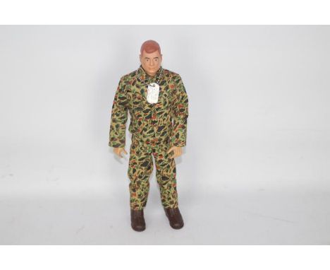 GI Joe, Hasbro - An unboxed vintage Hasbro GI Joe Action Marine figure. The red painted hard head figure is marked 'G.I. JOE 