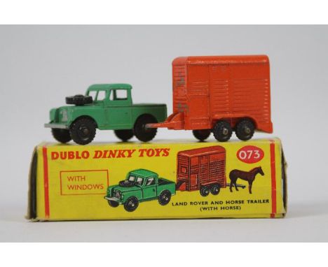 Dinky Toys - A boxed Dinky Dublo #073 Land Rover and Horse Trailer. The Land Rover in green with black knobbly black plastic 