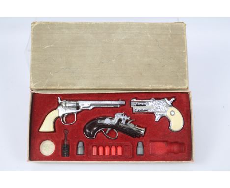 BCM (Derby), Cap Guns - A vintage boxed 'Outlaw Presentation Case of Miniature Antique Firearms' toy cap gun set by BCM. The 