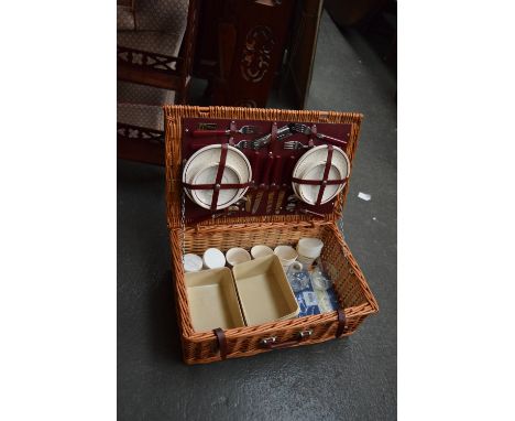 An Optima wicker picnic hamper with four place settings
