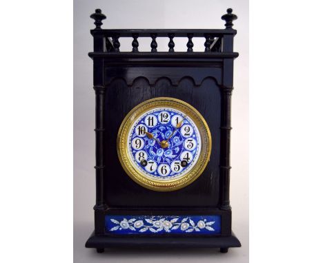 A Victorian ebonised and porcelain mounted mantel clock in the Aesthetic style, eight day movement striking on a gong, the ci