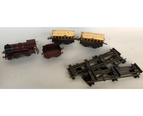 A vintage Hornby 0 Gauge clockwork Locomotive 500 with tender in maroon livery with two Pullman coaches together with some tr
