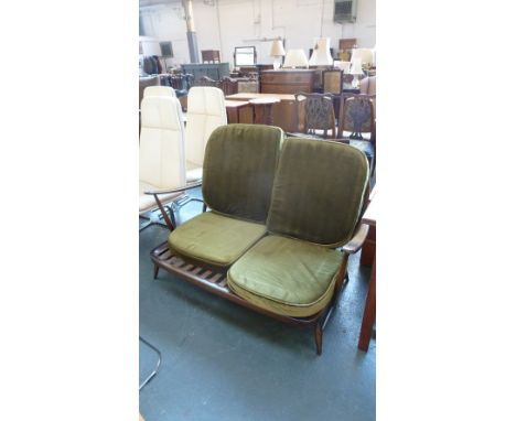 An Ercol Windsor style two seater sofa with removable green padded seat cushions (4)