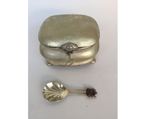 A silver tea caddy on four bun feet with lock and key,(probably German) hallmark worn and a caddy spoon decorated with the Ed