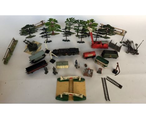 A selection of tin 00 gauge train and accessories to include a Locomotive 80054 in black livery, a coal tender in green liver