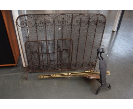 A selection of fire place accessories including a brass fireguard, a folding brass fire guard, a pair of small fire dogs and 
