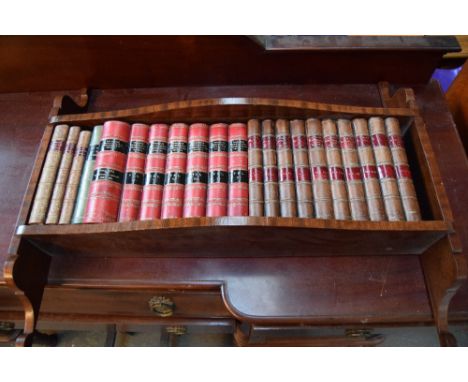 A walnut hanging shelf with faux fine bindings 74cmW