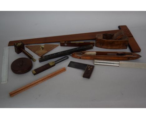 A mixed lot of wooden items and tools including a vintage wood loom shuttle, various rulers, set square, a Treble 78ft leathe