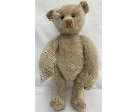 Steiff: An original, circa 1907, Steiff bear with boot button eyes, wood wool filled, creamy pale mohair, horizontal nose sti