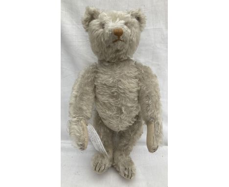 Steiff: An original, circa 1920, Steiff bear with white shaggy mohair, shield shaped nose, (later replacement), tapered long 