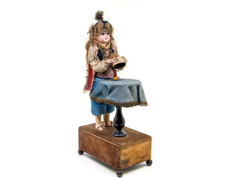 Renou: A late 19th century, magician automaton Victorian doll by Renou, with bisque head, marked to back of the head 'M1'. Th