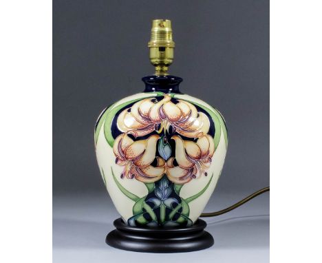 A modern Moorcroft pottery table lamp, tube-lined and decorated in colours with a clematis design, 10.5ins high, and shade fo