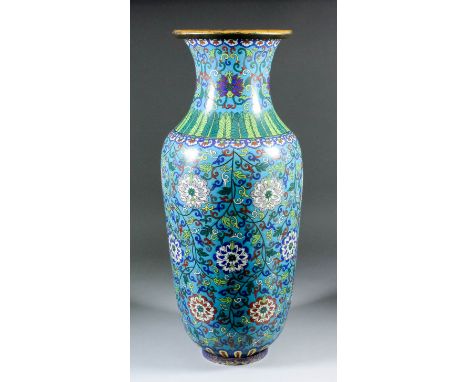 A Chinese cloisonné enamel baluster-shaped vase decorated with chrysanthemums and trailing leaf and scroll ornament, on a tur