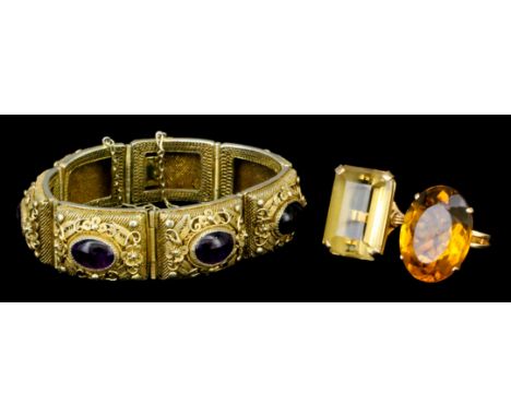An early 20th Century silver gilt filigree bracelet, the seven rectangular panels with floral work borders and set to the cen
