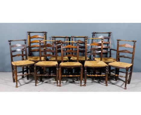 A set of nine early 19th Century "Lancashire" ash ladder back chairs (including two armchairs), with turned crest rails above