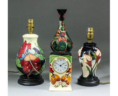 A modern Moorcroft pottery clock case, tube-lined and decorated in colours with "Anna Lily" design, designed by Nicola Slaney