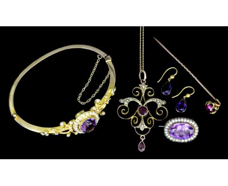 An Edwardian gold coloured metal mounted amethyst and seed pearl set stiff pattern bangle the oval cut amethyst of approximat