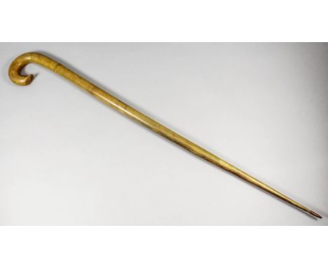 A late 19th Century rhinoceros horn two section walking stick, with metal tip, 35.5ins long
