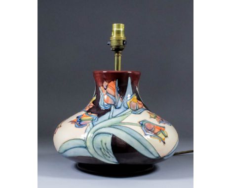 A modern Moorcroft pottery table lamp, tube-lined with a tulip design, 11ins high, and shade for same