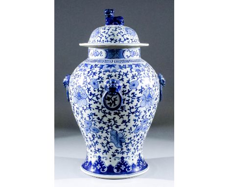 A Chinese blue and white porcelain baluster-shaped vase and cover with four moulded lion mask and ring handles to body, paint