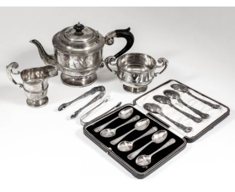 An Edward VII silver circular three piece tea service with moulded rim and girdle to bodies, double high scroll handles on ci