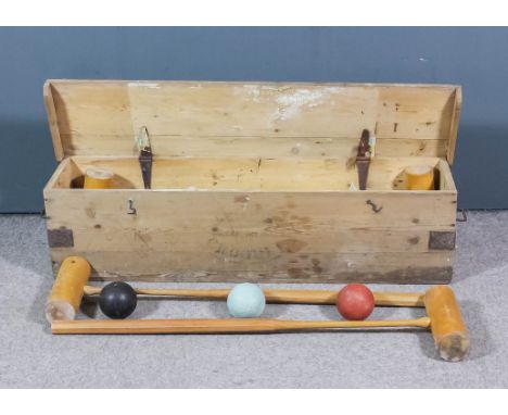 A Jacques croquet set for four, comprising - four mallets, four grooved colour balls, six heavy weight hoops, two posts, a wo