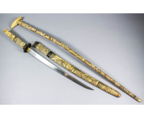 A 20th Century carved bone Japanese short sword, 17ins bright steel blade, metal fittings, scabbard and hilt carved with vill