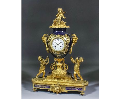 A late 19th Century French gilt metal and Royal blue glazed pottery mantel clock by CH. VCNE, No. 15008, the 3.75ins diameter