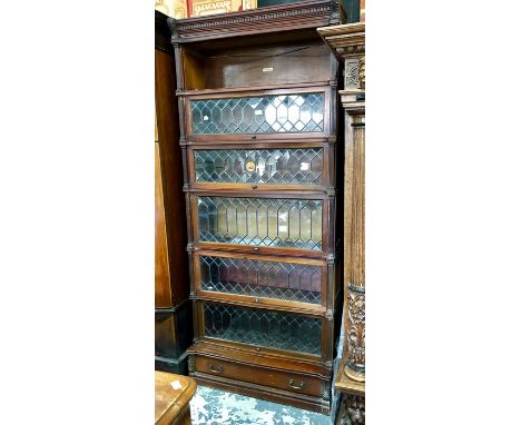 A six-section Globe Wernicke library bookcase, mahogany, with lattice lead glazed doors raised on a single drawer base sectio