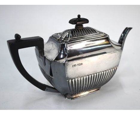 A late Victorian silver half-reeded teapot with ebonised handle and finial, Atkin Bros., Sheffield 1898, 18.1 oz gross