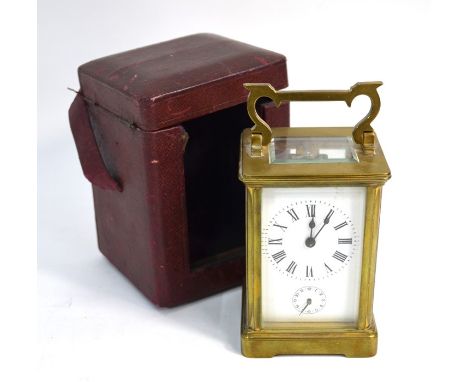 A late 19th century brass carriage clock, the eight-day alarm movement striking on a bell, in leather travel case, 12 cm high