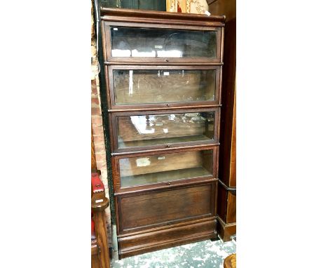 Globe Wernicke, a four glazed section oak library bookcase over an oak panelled base section, on a shaped plinth base, 87 cm 