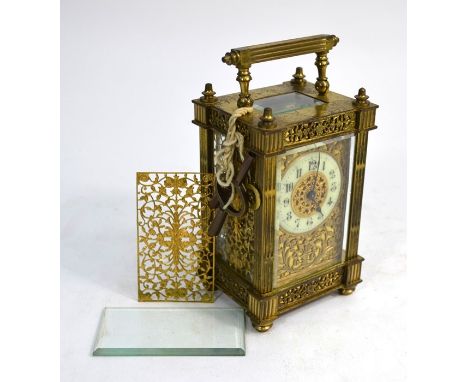 A 19th century Gothic style brass cased mantel clock, the eight-day movement with white porcelain chapter ring with Arabic nu