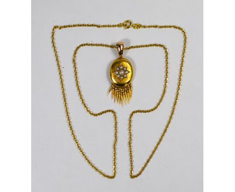 A Victorian oval pendant, the bloomed gold oval with seed pearl-set star, with articulated tassel fringe to lower edge and re