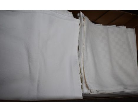 Two boxes containing a collection of ten M&amp;S lightly used cotton damask tablecloths and sets of napkins