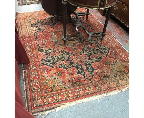 An old N.W Persian floral design rug, red and blue ground circa 1920's, 210 cm x 138 cm