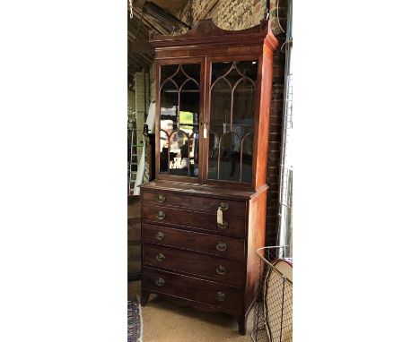 A 19th century mahogany secretaire bookcase, the pair of astragal glazed cabinet doors beneath a shaped cornice, over a well 